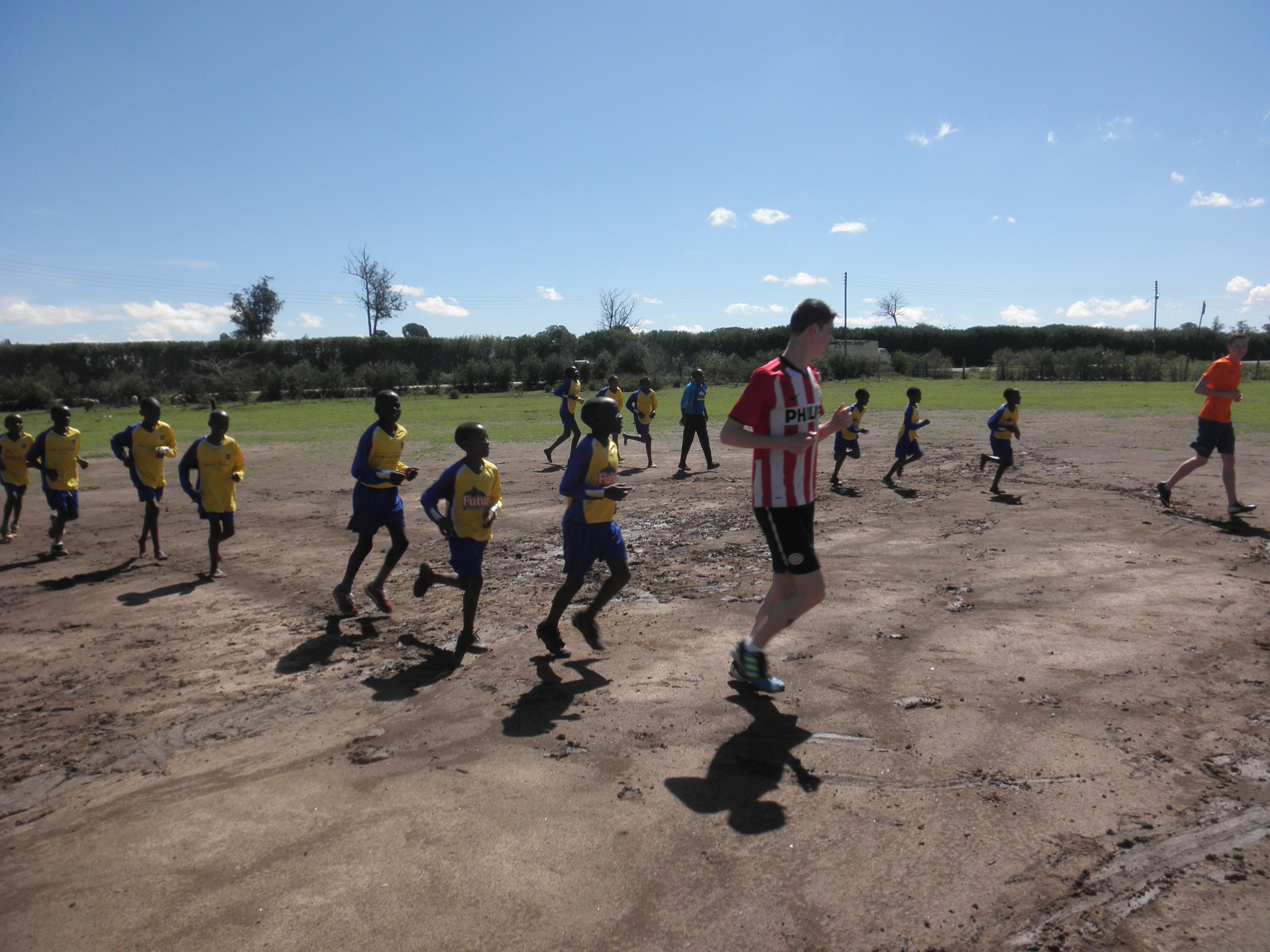 A Projects Abroad volunteer coaching sports with children in Kenya A volunteer teaching sports in Kenya teaches children a quick warm up